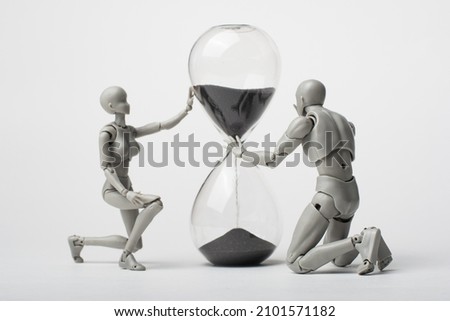 An attempt to stop time. Time spares no one. Regret for the past. Time is running away like sand. The grief of lost time. Missed opportunities. The past cannot be returned. Royalty-Free Stock Photo #2101571182