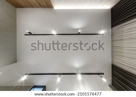 suspended or stretch ceiling with halogen spots lamps and drywall construction in empty room in apartment or house Royalty-Free Stock Photo #2101576477