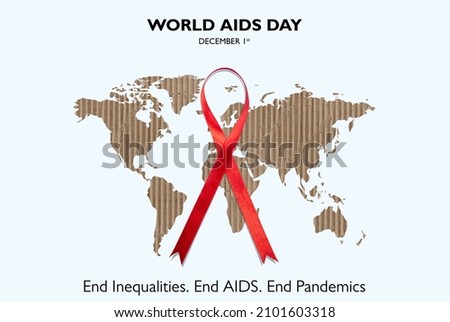 World Aids Day December 1st,  End Inequalities, End Aids, End Pandemics. Red Ribbon on world map card board cut out white Background