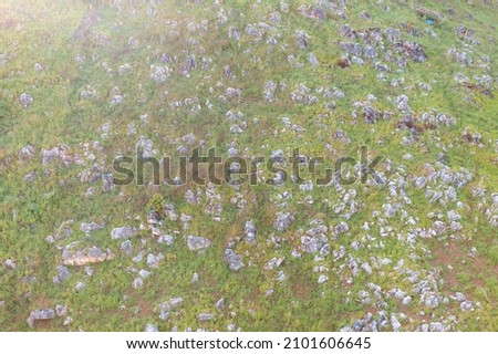 Aerial top view of rocks or stones on mountain hill with green forest trees. Nature landscape background in Thailand.