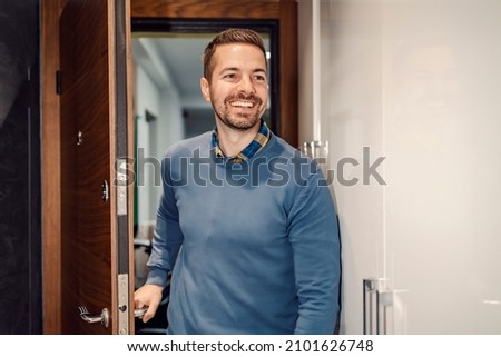 Home sweet home. A happy man is entering his house and shutting the door behind him. Royalty-Free Stock Photo #2101626748