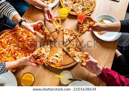 people eating pizza in cafe