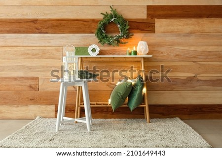 Interior of room with stool and table with Christmas decor