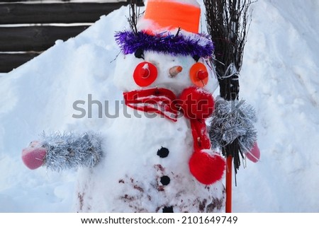 Winter bright snowman in the snow