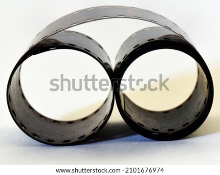 A roll of black and white film on white background.
