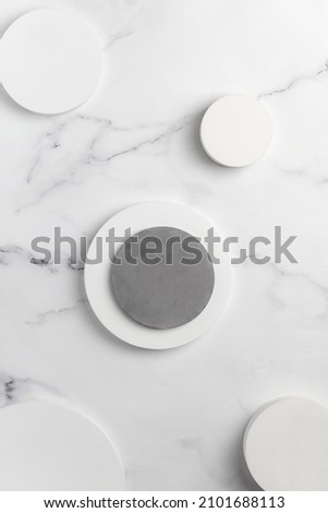 Podiums. White round podiums for presentation and cosmetic. Natural beauty pedestal on white marble background. Photography. Top view.