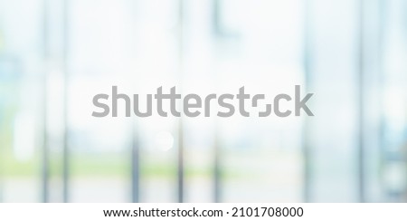 BLURRED OFFICE BACKGROUND, SPACIOUS BUSINESS INTERIOR HALL WITH DAY LIGHT WINDOW REFLECTIONS