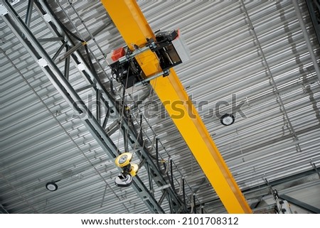 Modern remote control crane of a warehouse of a factory, inside Royalty-Free Stock Photo #2101708312