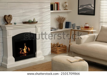 Stylish living room interior with comfortable sofa and decorative fireplace
