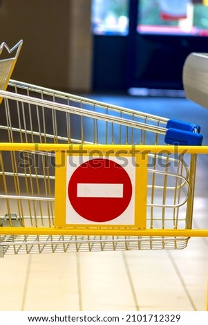 Trolley in the store. stop sign. Concept of ban, end of trade. Closed shops. Store barrier