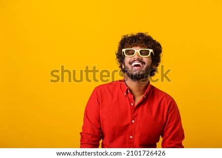 Positive bearded man laughing out loud, chuckling and hysterically laughing with anecdote, having fun. Indoor studio shot isolated on orange background Royalty-Free Stock Photo #2101726426