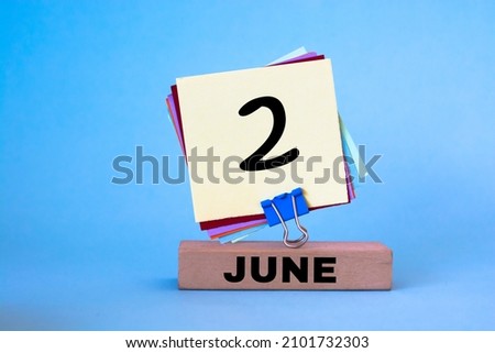 June 2nd. Image of June 2 wooden color calendar on blue background. Summer day, empty space for text