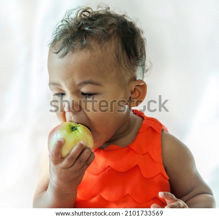 10 month old baby biting into apple