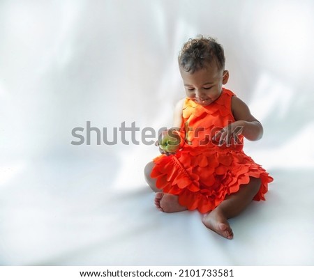 10 month old baby playing with an apple