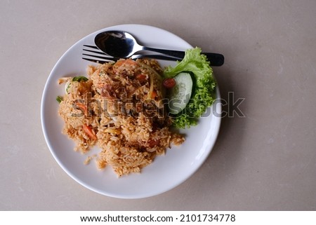 Seafood fried rice with salad and cucumber close up picture. 
