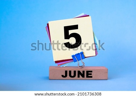 June 5th. Image of June 5 wooden color calendar on blue background. Summer day, empty space for text