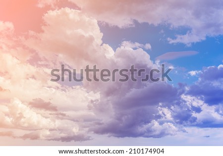 White clouds with blue sky background. Color toned image.