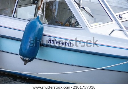 Boat detail with the inscription HAFENAMT (meaning Port Authority) in the city harbour of Greifswald-Wieck, Hanseatic City of Greifswald, Mecklenburg-Western Pomerania, Germany. Royalty-Free Stock Photo #2101759318