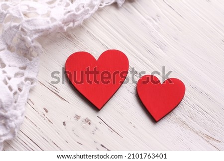 Two red hearts on a white wooden background. Valentine's Day