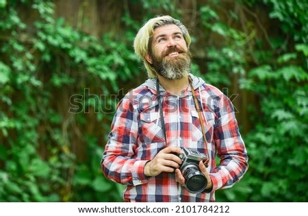 photo shooting outdoor. brutal man traveler with retro camera. photography in modern life. travel tips. professional photographer use vintage camera. bearded man hipster take photo. idyllic vacation