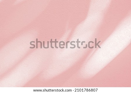 shadow and light bokeh pink background of leaf shadow tree branch on white wall texture, nature leaves pink rose gold shadow overlay effect, mock up and design
