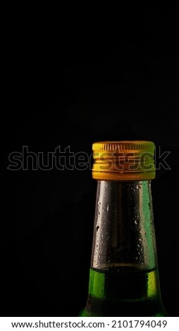 Close up, bottles and drops of water and a black background that gives a dramatic feel. Food and drink concept. Art Photography. Food Photography. vertical photo