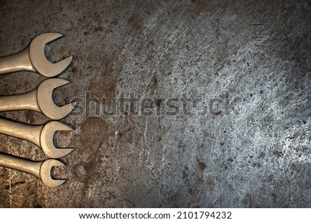 Background with wrenches on a metal workbench. Industrial composition for calendar, advertisement or business card