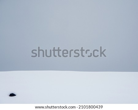 Gray gradient, snowdrift on a gray sky background. Snowy surface, abstract background.