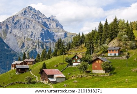 Mountain village on the mountainside. Village in mountains Royalty-Free Stock Photo #2101818271