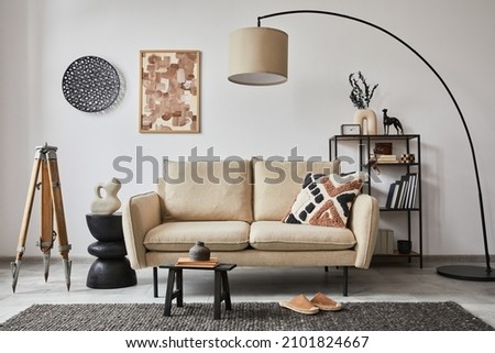 Creative composition of modern living room interior with mock up poster frame, beige sofa, side table and stylish small personal accessories on metal shelf. Copy space. Template. 
