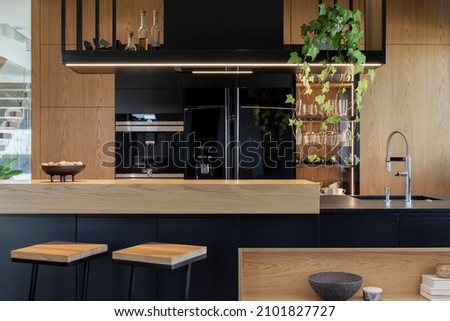 Minimalistic modern wooden panel kitchen interior with ergonomic biuld-in kitchen and kitchen island. Geometric forms and shapes. Details. Template. 
