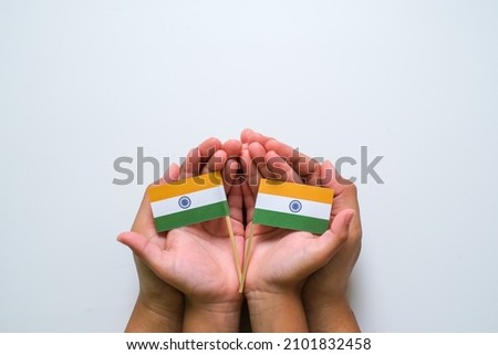 Hand holding and touching national India Flag , India independence day concept, India republic day concept
