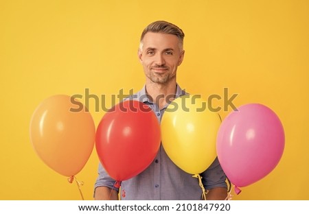 seasonal sales. man with party balloons. present and gifts buy. mature shopping guy with purchase