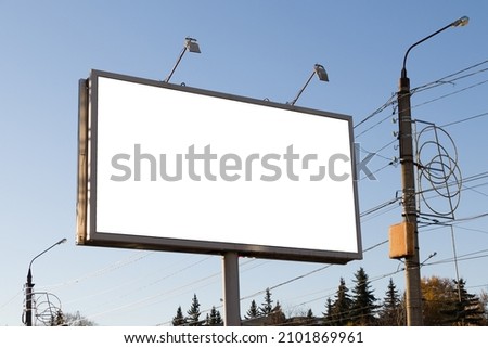 large blank billboard outdoors with blue sky background