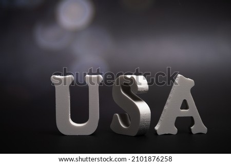 USA, word dark background with bokeh. Signs and Symbols.