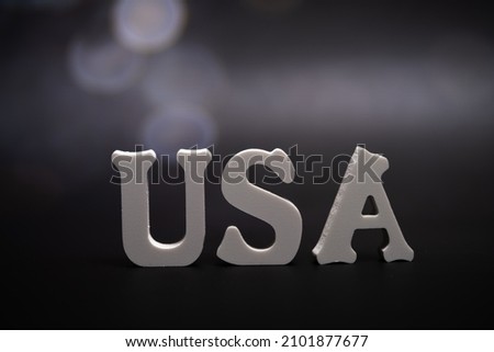 USA, word dark background with bokeh. Signs and Symbols. Royalty-Free Stock Photo #2101877677