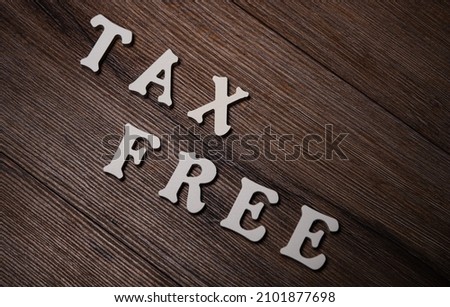 Text tax on wooden background. Financial concept. Royalty-Free Stock Photo #2101877698
