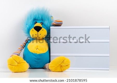 Empty lightbox with lion toy on white table. Mockup concept.