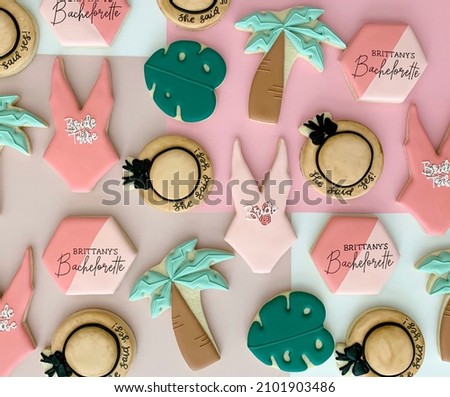Bachelorette cookies made for a Bachelorette party in Palm Springs. Tropical themes with sun hats, palm leaves, palm trees and swimsuits.