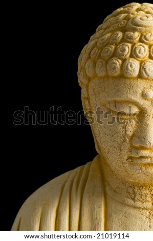 close up of stone buddha in meditation with black background