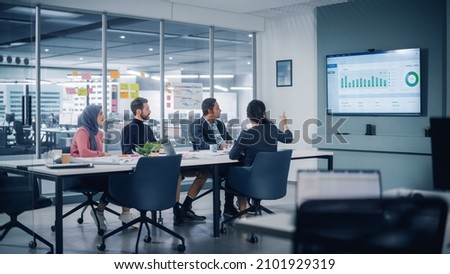 Multi-Ethnic Office Conference Room Meeting: Diverse Team of Successful Managers, Executives Talk, Use Green Screen Chroma Key TV. Businesspeople Investing in Growing e-Commerce Startup.