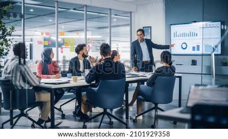 Presentation in Multi-Ethnic Office Conference Room. Meeting of Diverse Young Entrepreneurs, Specialists, Talking, Using TV for infographics. Businesspeople Develop e-Commerce Startup. Royalty-Free Stock Photo #2101929358