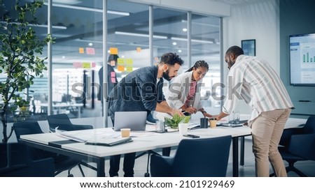 Diverse Team of Professional Businesspeople Meeting in the Office Conference Room. Creative Team Around Table, Black Businesswoman, African-American Digital Entrepreneur and Hispanic CEO Talking. Royalty-Free Stock Photo #2101929469