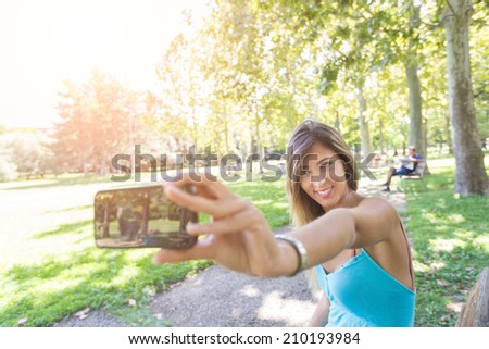 Beautiful Young Woman Taking Selfie at Park