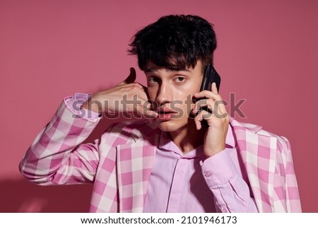 pretty man fashionable talking on the phone pink blazer posing studio Lifestyle unaltered