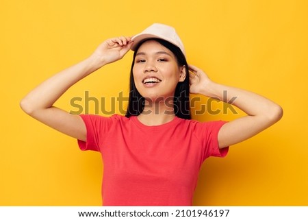 pretty brunette in a red t-shirt with a cap on her head
