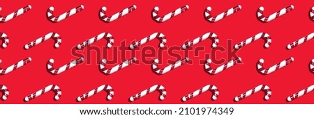 Banner with red-white candy cane seamless pattern on a red background.