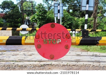 Photo of a Stop sign in a railway crossing gate