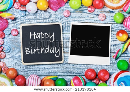 blackboard with congratulations to the happy birthday and photo frame