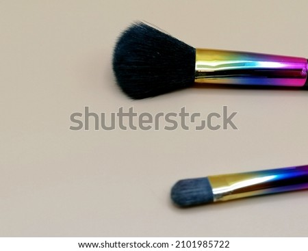 Brushes of various colors for women's makeup.